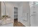 Spacious bathroom with a glass shower, granite countertop, white cabinetry, and a walk-in closet at 18916 W Laurel Ln, Surprise, AZ 85388