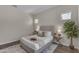 Comfortable bedroom featuring a neutral color scheme, wood floors, and decorative pillows and throws at 18916 W Laurel Ln, Surprise, AZ 85388