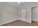 Bright bedroom featuring wood floors and a modern sliding door at 18916 W Laurel Ln, Surprise, AZ 85388