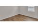 The bedroom showcases attractive wood-look flooring and a bright window with blinds at 18916 W Laurel Ln, Surprise, AZ 85388