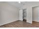 Bright bedroom featuring wood floors and a modern sliding door to the laundry room at 18916 W Laurel Ln, Surprise, AZ 85388
