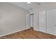 A bedroom features wood-look flooring, a ceiling fan, and a large closet with doors at 18916 W Laurel Ln, Surprise, AZ 85388