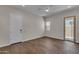 The bonus room features wood-look flooring, a ceiling fan, and a glass door at 18916 W Laurel Ln, Surprise, AZ 85388