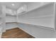 Large walk-in closet with ample shelving and cabinet space for organized storage at 18916 W Laurel Ln, Surprise, AZ 85388