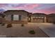 Charming single-story home with a neutral color palette, a two car garage, and low-maintenance landscaping at 18916 W Laurel Ln, Surprise, AZ 85388