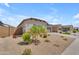 Suburban home with low-maintenance landscaping, two-car garage, and tile roof, situated in a quiet neighborhood at 18916 W Laurel Ln, Surprise, AZ 85388
