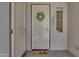 Inviting entryway with decorative front door, adorned with a wreath and a charming 'hello' doormat at 18916 W Laurel Ln, Surprise, AZ 85388