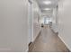 Long hallway featuring wood-look tile flooring, leading into a bright and open living space at 18916 W Laurel Ln, Surprise, AZ 85388