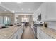 Stylish kitchen with white cabinets, stainless steel appliances, and a view of the dining area at 18916 W Laurel Ln, Surprise, AZ 85388