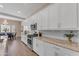 Elegant kitchen featuring granite countertops, white cabinetry, and stainless steel appliances at 18916 W Laurel Ln, Surprise, AZ 85388