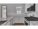 Bright kitchen with white cabinets, granite countertops, subway tile backsplash, and stainless steel appliances at 18916 W Laurel Ln, Surprise, AZ 85388