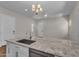 This kitchen boasts granite counters and stainless steel appliances overlooking the open floorplan at 18916 W Laurel Ln, Surprise, AZ 85388