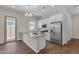 Modern kitchen featuring white cabinets, granite countertops, and stainless steel appliances at 18916 W Laurel Ln, Surprise, AZ 85388