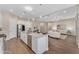 Open-concept kitchen with stainless steel appliances, large island, and seamless flow into the living area at 18916 W Laurel Ln, Surprise, AZ 85388