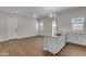 Bright kitchen featuring white cabinets, a granite countertop island, and stainless steel appliances at 18916 W Laurel Ln, Surprise, AZ 85388