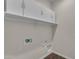 The laundry room offers upper cabinets and plenty of space for laundry appliances at 18916 W Laurel Ln, Surprise, AZ 85388