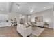 Open-concept living room with sleek furniture, decor, and ample natural light at 18916 W Laurel Ln, Surprise, AZ 85388