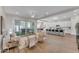 Bright, open-concept living room featuring tile floors, neutral paint, and a seamless flow to the kitchen at 18916 W Laurel Ln, Surprise, AZ 85388