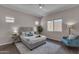 Serene main bedroom with neutral tones, a large window, and comfortable seating at 18916 W Laurel Ln, Surprise, AZ 85388