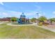 Community playground area with a blue playset, walking path, and shelter at 18916 W Laurel Ln, Surprise, AZ 85388