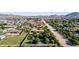 Wide aerial view of the neighborhood, showcasing lush landscaping and views of the mountains in the distance at 19006 E Karsten Dr, Queen Creek, AZ 85142