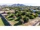 Aerial view of the yard featuring desert landscaping, large mature trees, and fencing at 19006 E Karsten Dr, Queen Creek, AZ 85142