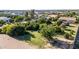 Aerial view of the home's backyard featuring mature trees, desert landscaping, and a cozy fire pit at 19006 E Karsten Dr, Queen Creek, AZ 85142