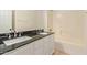 This bathroom features a double sink vanity with black countertops at 19006 E Karsten Dr, Queen Creek, AZ 85142