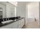 Bathroom view features a large mirror, double sink, tub and tile flooring at 19006 E Karsten Dr, Queen Creek, AZ 85142