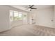 The bedroom has carpet flooring, a ceiling fan and a large bay window view into the backyard at 19006 E Karsten Dr, Queen Creek, AZ 85142