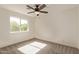 The bedroom features natural light, carpeted floors, and a ceiling fan at 19006 E Karsten Dr, Queen Creek, AZ 85142