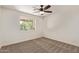 Bedroom featuring carpet floor, ceiling fan and window with backyard views at 19006 E Karsten Dr, Queen Creek, AZ 85142
