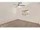 This bedroom features carpeted floors, a ceiling fan, and a window at 19006 E Karsten Dr, Queen Creek, AZ 85142