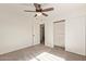 This bedroom boasts carpeted floors, a closet, and a ceiling fan at 19006 E Karsten Dr, Queen Creek, AZ 85142