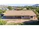 Aerial view of the house's back exterior showing the covered patio and desert landscaping at 19006 E Karsten Dr, Queen Creek, AZ 85142