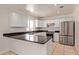 Modern kitchen with white cabinetry, granite counters, stainless steel appliances, and tile flooring at 19006 E Karsten Dr, Queen Creek, AZ 85142