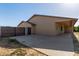 Side yard featuring a metal gate, stucco wall, and covered parking with windows at 19006 E Karsten Dr, Queen Creek, AZ 85142