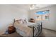 Cozy bedroom with a metal frame bed, window views, and neutral colored walls at 2004 E Heartwood Ln, Phoenix, AZ 85022