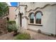 Charming home with a stone-paved walkway leading to an inviting entryway with beautiful architectural detailing at 2004 E Heartwood Ln, Phoenix, AZ 85022
