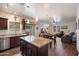 Spacious kitchen with an open layout that includes an island, stainless steel appliances, and a view into the living area at 2004 E Heartwood Ln, Phoenix, AZ 85022