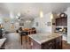 Modern kitchen with an island that flows into a living space, featuring natural light and modern design at 2004 E Heartwood Ln, Phoenix, AZ 85022