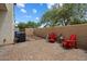 Charming brick patio with red Adirondack chairs, perfect for outdoor relaxation and enjoying sunny afternoons at 2004 E Heartwood Ln, Phoenix, AZ 85022