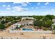 Aerial view of a home with a private pool, desert landscaping, and outdoor fire pit at 21205 E Excelsior Ave, Queen Creek, AZ 85142