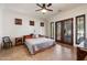 Comfortable primary bedroom boasts a cozy bed, shuttered windows, and a ceiling fan for added comfort at 21205 E Excelsior Ave, Queen Creek, AZ 85142