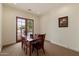 Bright dining room with wood table and chairs, bathed in natural light from the french doors to the backyard at 21205 E Excelsior Ave, Queen Creek, AZ 85142