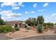 Beautiful home featuring desert landscaping, a circular driveway, and an elegant wrought iron gate at 21205 E Excelsior Ave, Queen Creek, AZ 85142