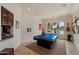 Bright game room features a pool table, wet bar with marble countertop, arched windows, and musical instrument display at 21205 E Excelsior Ave, Queen Creek, AZ 85142