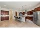 Spacious kitchen with an expansive island, stainless steel appliances, and custom cabinets at 21205 E Excelsior Ave, Queen Creek, AZ 85142