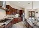 Gourmet kitchen featuring granite countertops, stainless appliances, and a farmhouse sink at 21205 E Excelsior Ave, Queen Creek, AZ 85142
