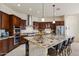 Open kitchen featuring a large island, stainless appliances, and custom cabinetry at 21205 E Excelsior Ave, Queen Creek, AZ 85142